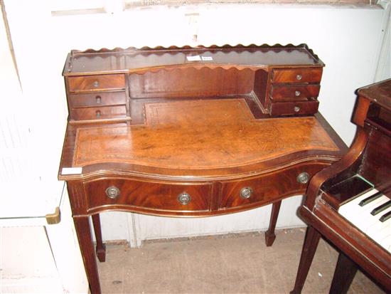 Mahogany serpentine fronted writing table(-)